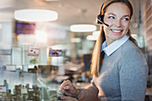 Smiling businesswoman with headset working