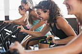 Smiling woman using elliptical bike