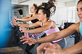 Energetic women riding elliptical bikes