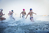 Female swimmers running and splashing