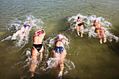 Overhead view female swimmers swimming