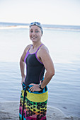 Portrait female swimmer wrapped in towel