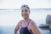 Portrait confident female swimmer at ocean