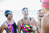 Laughing female swimmers talking