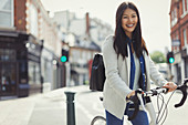 Portrait businesswoman commuting on bicycle