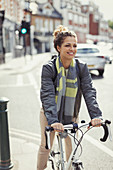 Smiling woman commuting, riding bicycle