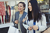 Smiling, happy women with shopping bags