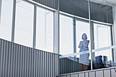 Portrait CEO businesswoman standing at window