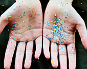 Star confetti glitter on hands