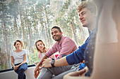 Smiling people listening in group therapy session
