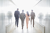Business people walking in office corridor