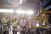 Steelworkers walking and talking in steel mill