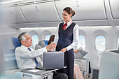 Flight attendant serving drink