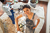 Portrait confident woman painting living room