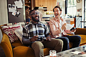 Laughing men friends playing video game