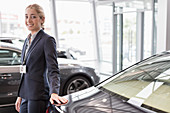 Portrait car saleswoman in showroom