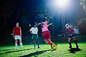 Young soccer players practicing at night