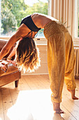 Flexible woman practicing yoga backbend