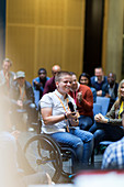 Smiling woman in wheelchair speaking
