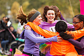 Enthusiastic female runners finishing charity run