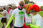 Portrait runners in wigs and Holi powder