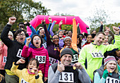 Portrait cheering crowd with medals finishing run