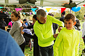 Father pinning marathon bib on son tent
