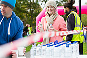 Portrait smiling volunteer handing out water