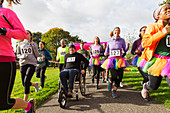 Man in wheelchair among runners