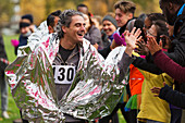 Enthusiastic marathon runner in thermal blanket
