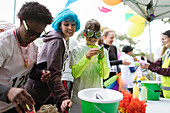 Runners with wig and Holi powder tent