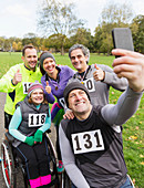 Man in wheelchair taking selfie with friends