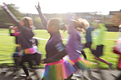 Enthusiastic runners in tutus running