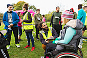 Woman in wheelchair checking in with volunteer