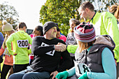 Runner shaking hands with man in wheelchair