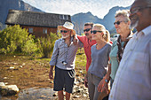 Happy, active seniors outside summer cabin
