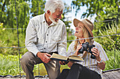 Smiling active senior couple bird watching