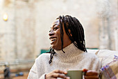 Laughing, happy woman drinking coffee