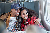 Affectionate young couple sharing headphones