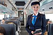 Portrait confident female attendant on train