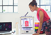 Female designer watching 3D printer