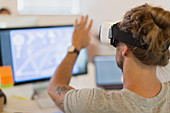 Computer programmer testing VR glasses