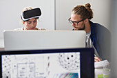 Computer programmers programming VR glasses