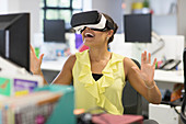 Enthusiastic businesswoman using VR glasses