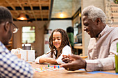 Grandfather and granddaughter playing board game