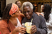 Senior father and daughter toasting lemonade