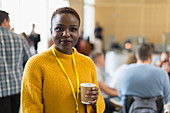 Portrait businesswoman drinking coffee at conference