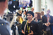 Cameraman filming businesswoman talking at conference