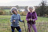 Portrait active senior women hikers with poles