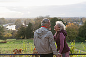 affectionate active senior couple in autumn park